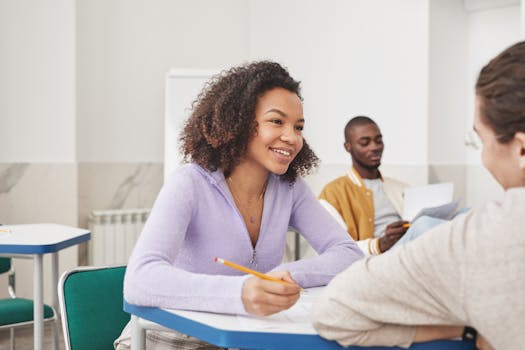 Group of diverse students interacting and studying in a classroom environment.